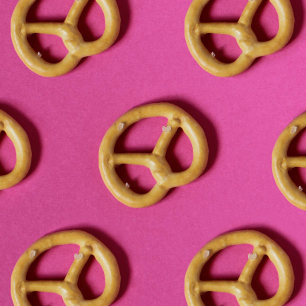 istock Pretzel on a pink paper  background.  Creative concept. Abstract photo. Template. 961482846