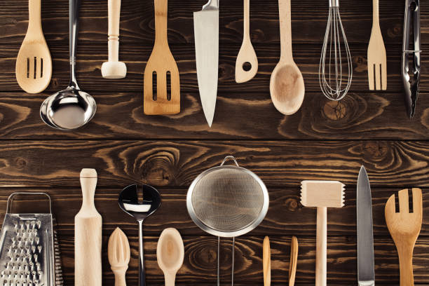 istock top view of different kitchen utensils placed in two rows on wooden table 961488574