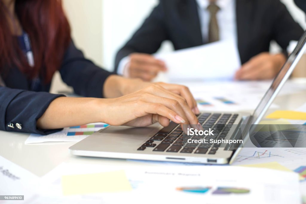 close up hand of business woman employees secretary using laptop  minutes  of executive meeting - business concept Minute Hand Stock Photo