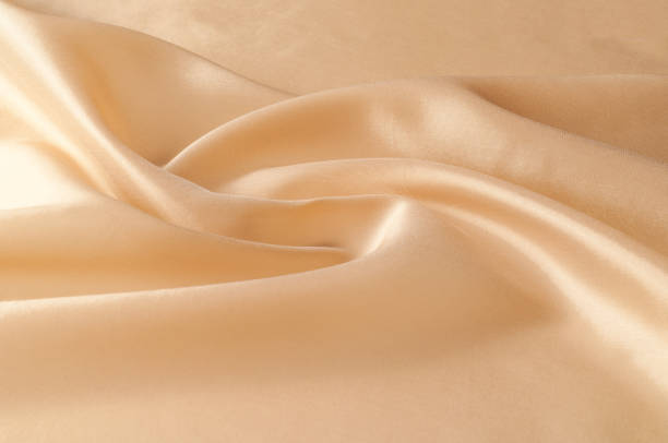 istock Texture background of fabric. Beige fabric. Silk fabric wallpaper texture background pattern in sepia pastel yellow cream beige tint: Lovely natural silk textured textile 961489782