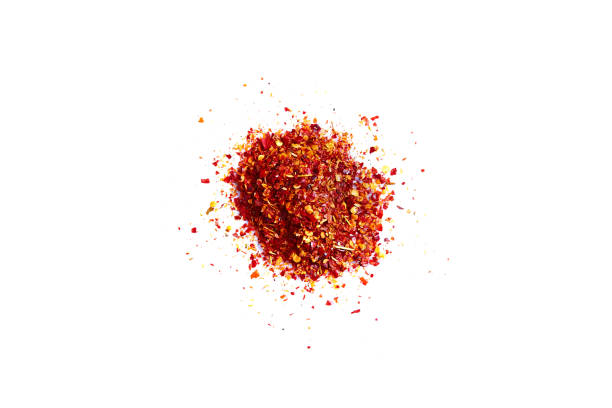 Crushed red pepper chilli pile from top on white background stock photo