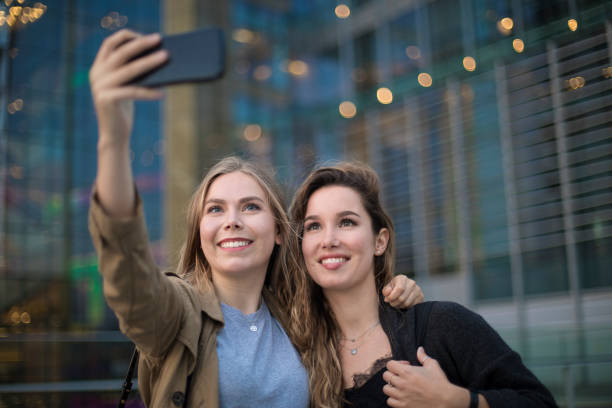istock Two friends making a selfie at the city. 961493098