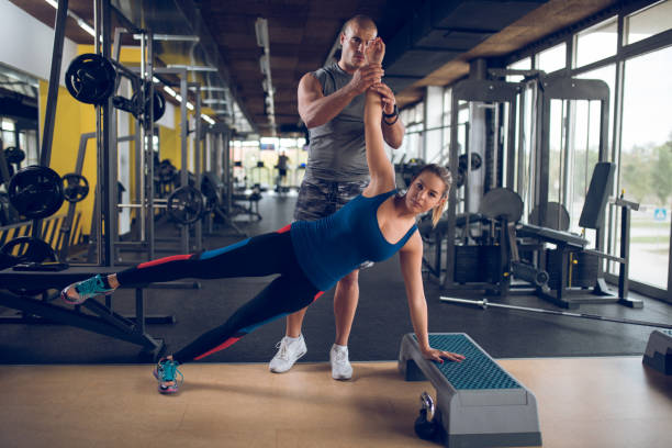 istock Young woman exercising on step aerobics equipment at gym 961493242