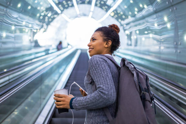 istock Young woman on subway escalator 961493680