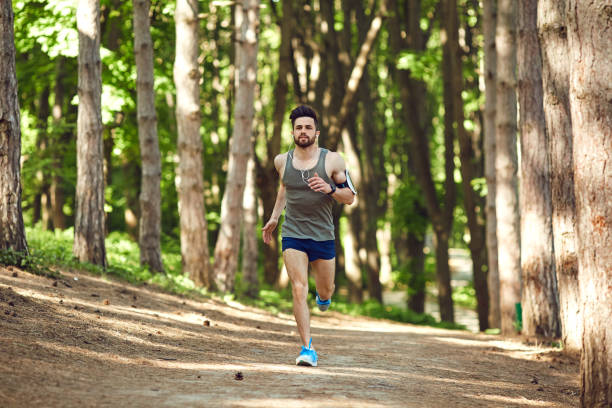 istock A young male runner runs in the forest 961494594