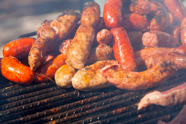istock Cooking fresh Sausages on grill. Latin America. 961495702