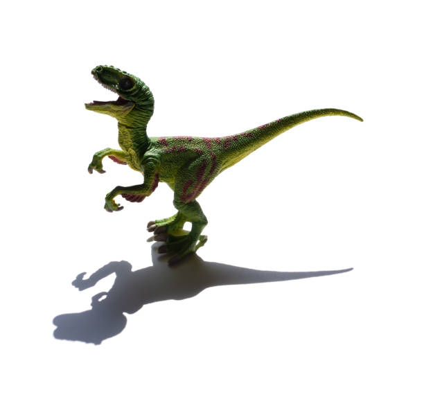Dinosaur toys in Christmas Santa hats behave  like they are having fun at a Christmas party.