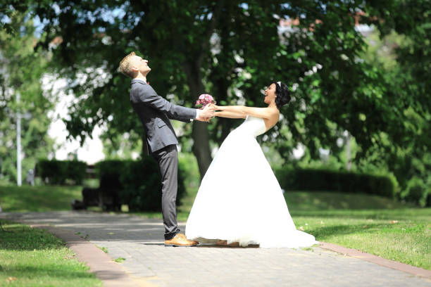 istock happy bride and groom circling in the Park 961505962