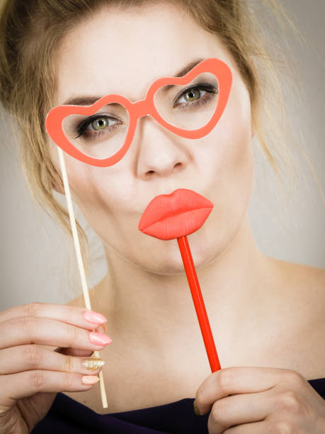 istock woman holds carnival accessories on stick 961505988
