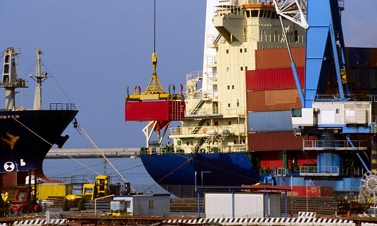 Cargo ship loading container on the commercial dock