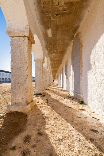 The arcades of the pilgrim lodgings in the Baroque Sanctuary of Nossa Senhora do Cabo, aka Nossa Senhora da Pedra Mua in Espichel Cape. Sesimbra, Portugal