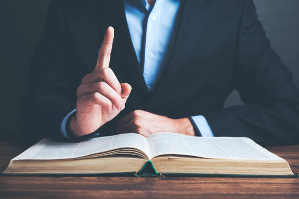 istock man reading book on wooden table background 961507502