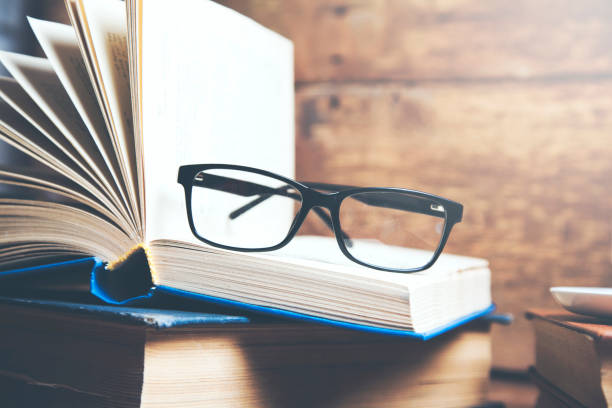 istock glasses on books on wooden table background 961507532