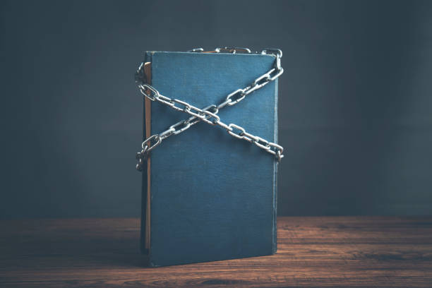 istock book chained with lock on wooden table 961507544