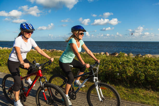 istock Woman riding bike at seaside 961507582