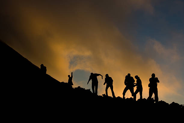 A team of walkers start climbing the Pacaya Volcano at sunset