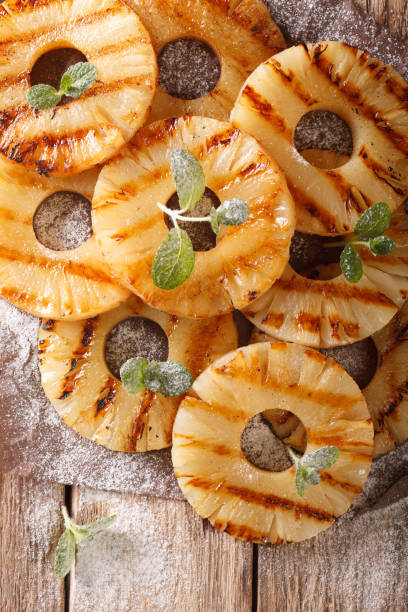 istock grilled pineapple with mint and powdered sugar close-up on the table. vertical top view 961510678