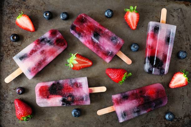 istock Healthy berry fruit popsicles, flat lay on a dark background 961511020