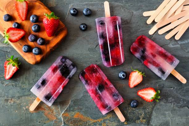 istock Healthy berry fruit popsicles, top view on a dark background 961512026