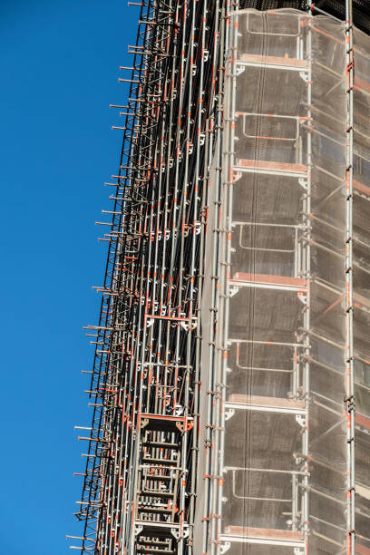 istock Large facade scaffold house construction site in the sunshine 961515174