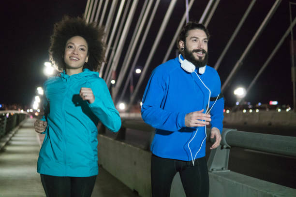 istock Happy fit couple jogging at nigh 961516724