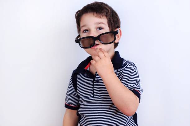 funny photo of cute little boy putting on sunglasses, studio sho - studio sho imagens e fotografias de stock