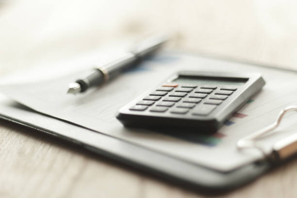 istock close up. blurred image of pen and calculator on desktop 961517130