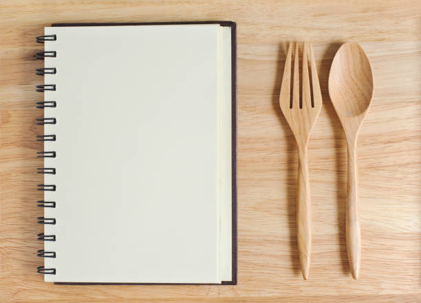 istock empty wood plate with notebook open and spoon ,frok 961519714