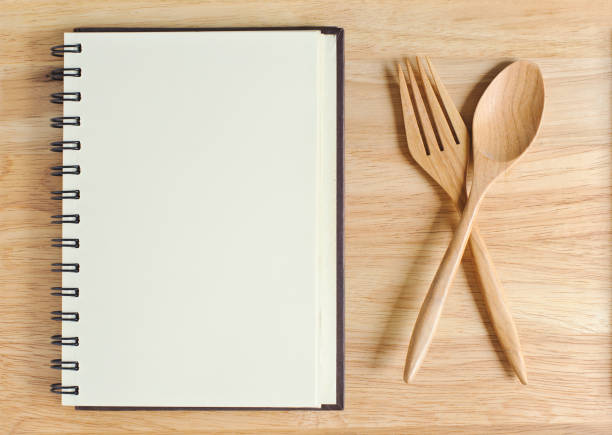 istock empty wood plate with notebook open and spoon ,frok 961520144