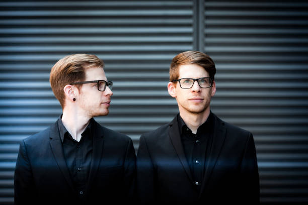 twin portrait twin brothers with black suits and glasses. two men same clothes stock pictures, royalty-free photos & images