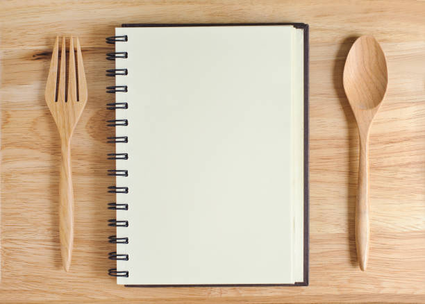 istock empty wood plate with notebook open and spoon ,frok 961520248