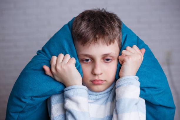 istock Upset stressed boy covering his head and ears blocking out the s 961520504
