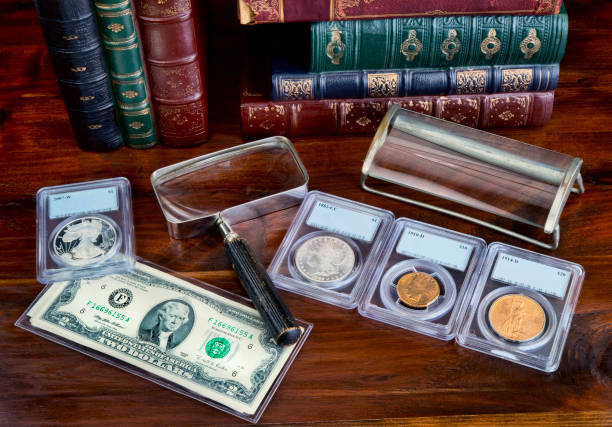 Coin Collecting. Coin collection with on table with literature. coin collection stock pictures, royalty-free photos & images