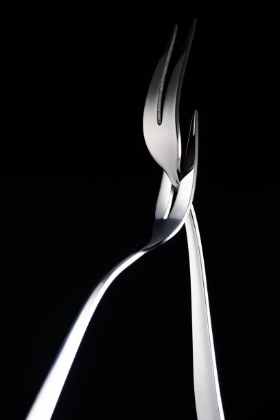 istock two forks with two tines isolated on black 961523996