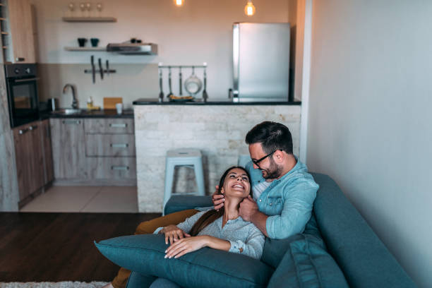 istock Cute couple cuddling on the sofa. 961524008