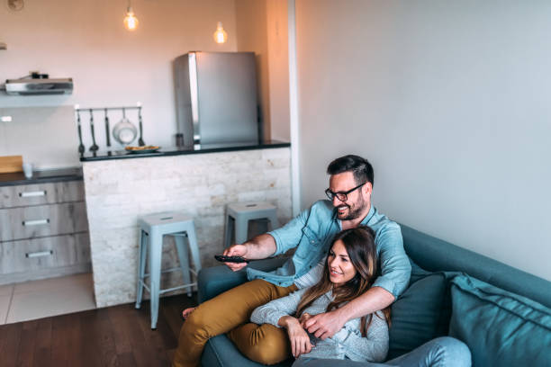 istock Young couple watching tv. 961524024