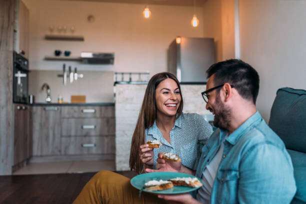 istock Happy couple eating on the sofa. 961524118