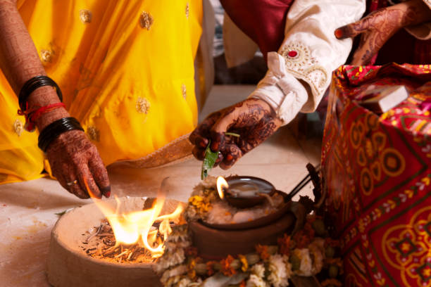 istock Bride and groom offering to holy fire at mandap, a typical wedding ritual during an Indian marriage. 961524576