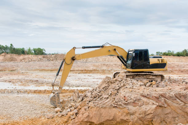 istock Yellow excavator machine working earth moving works at construction site 961525306