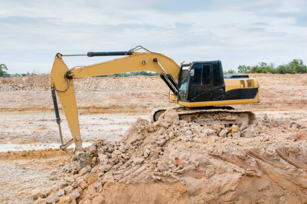 istock Yellow excavator machine working earth moving works at construction site 961525738