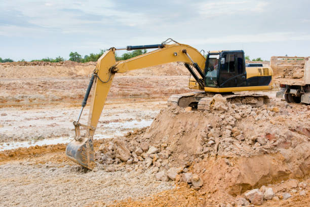 istock Yellow excavator machine working earth moving works at construction site 961525858