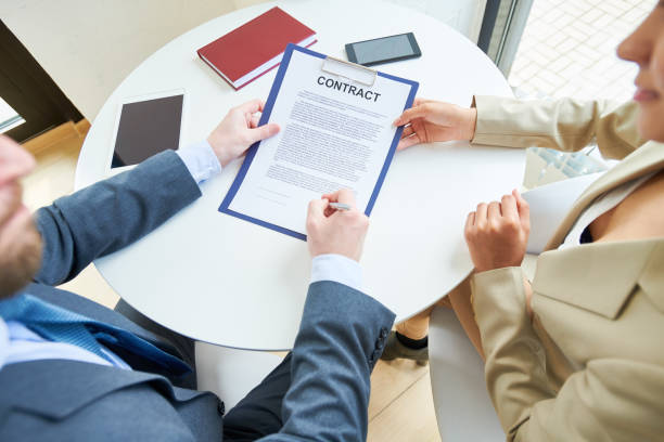 istock Business People Signing Contract Above View 961525908