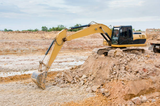 istock Yellow excavator machine working earth moving works at construction site 961525960