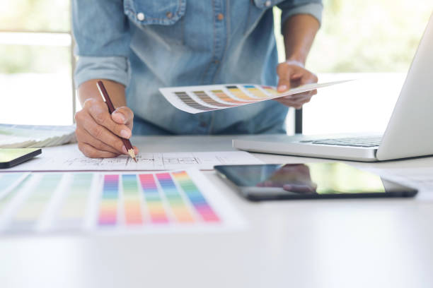 istock Creative creativity graphic designer working with graphics tablet,laptop and smart phone, colour chart at workplace on wooden desk , colour ideas style concept 961528454