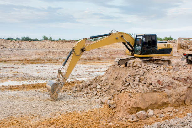 istock Yellow excavator machine working earth moving works at construction site 961529186