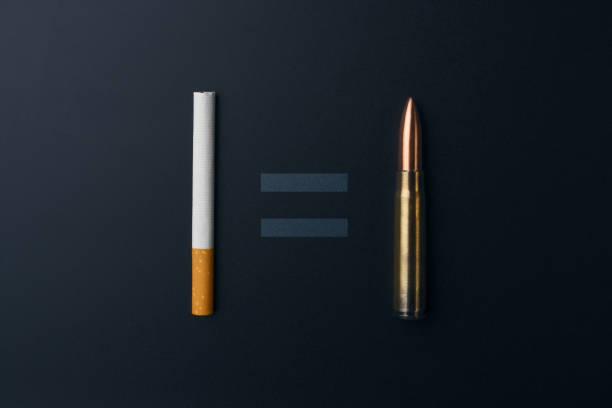 cigarette and gun bullet with equality sign on dark background - addiction ammunition weapon army imagens e fotografias de stock