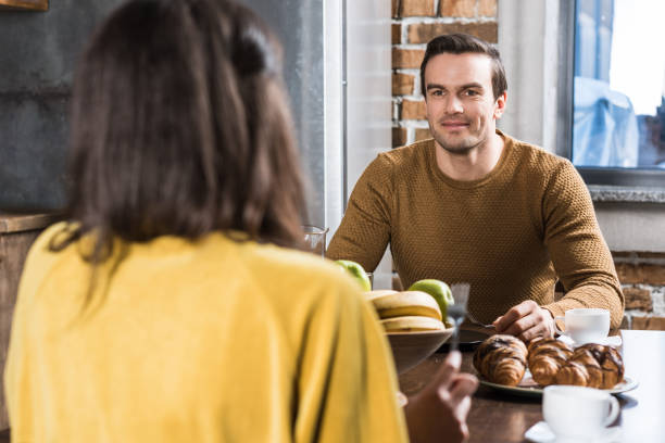 istock selective focus of couple looking at each other while having breakfast together at home 961535270