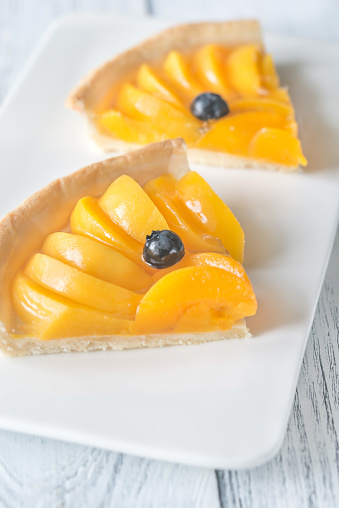 Slices of tart with peaches and blueberry