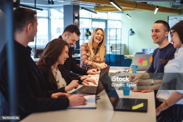 Happy Colleagues Laughing In The Office Meeting Stock Photo - Download Image Now - Teamwork, Office, Working