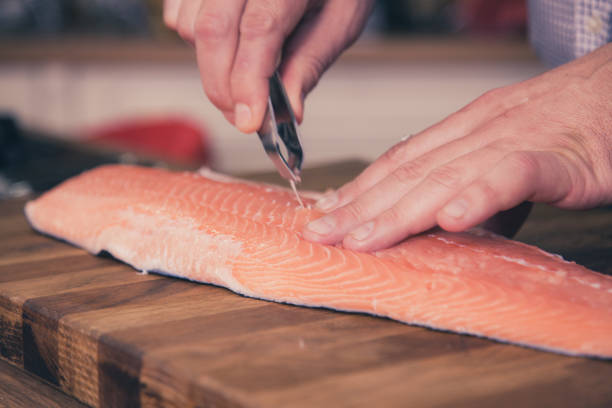 istock Removing fish bones out of salmon. 961542772